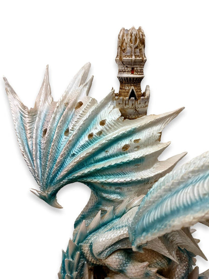 Blauer, weißer Drache auf einer Burg